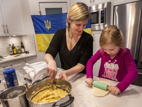 Lia Butler and her four-year-old daughter Raia Butler make perogies in their Royal Bay home.
