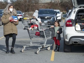 Mandy Alves and her children Isla, 3, and Nina, 14-months, after finishing grocery shopping.