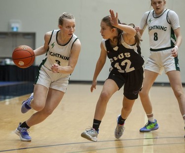 Langley, BC: MARCH 04, 2022 -- Langley Christian Lightning's Sydney Bradshaw tries to drive the ball downcourt while being guarded by St. Michaels University School Blue Jags' Avery Geddes during the Double A semifinal game of girls basketball provincial championships at the Langley Events Centre in Langley, BC Wednesday, March 4, 2022. 



(Photo by Jason Payne/ PNG)

(For story by Steve Ewen) ORG XMIT: basketball [PNG Merlin Archive]