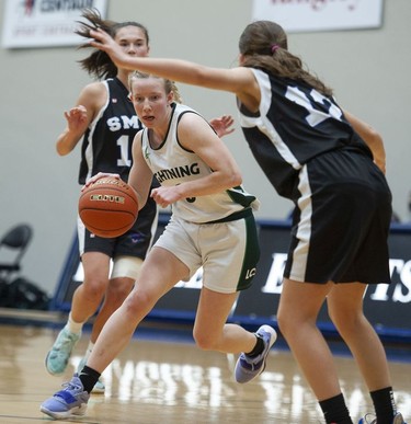 Langley Christian Lightning's Sydney Bradshaw drives the ball downcourt during play against the St. Michaels University School Blue Jags in the Double A semifinal game of girls basketball provincial championships at the Langley Events Centre.