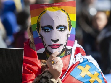 A image mocking Russian President Vladimir Putin is held up at a rally for Ukraine at the Vancouver Art Gallery in Vancouver, BC Saturday, March 5, 2022.
