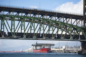 The Tsleil-Waututh Nation have commissioned reports documenting the erosion of the shoreline around Burrard Inlet, changes to sea life and industrial pollution since contact. Pictured is a cargo ship as seen from Burrard Inlet March 8, 2022. Foreground Second Narrows rail and road bridges.