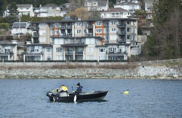 The Tsleil-Waututh Nation have commissioned reports documenting the erosion of the shoreline around Burrard Inlet, changes to sea life and industrial pollution since contact. Pictured are fishermen in the Burrard Inlet March 8, 2022.