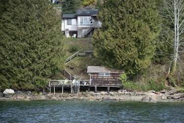 The Tsleil-Waututh Nation have commissioned reports documenting the erosion of the shoreline around Burrard Inlet, changes to sea life and industrial pollution since contact. Pictured is a house on the shores of Burrard Inlet Tuesday, March 22, 2022.