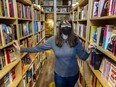 Patricia Massy at her bookstore Massy Books in Vancouver is askng customers to keep wearing masks, at least for now.