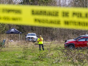 Homicide police are pictured in the 7400 block of 208th Street in Langley, B.C. on Wednesday afternoon after Langley RCMP located a body in a vacant lot a day earlier.