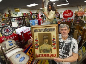 Mad Picker Wayne Leary holds a rare early Queen Alexandra Lager Sign that was pieced together from two scraps of tin from a shed in the interior. It was owned by Mike Wagner, a Vancouver collector who died Dec. 22, 2021.