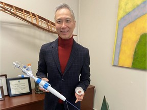 Photo of St. Paul's Hospital cardiac surgeon Dr. Anson Cheung with his new device known as the Transcatheter Tricuspid Valve.
