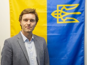 Dr. Florian Gassner with the Ukrainian flag at UBC in Vancouver.