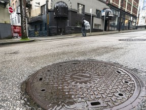 A CPR manhole cover probably dating to the 1890s sits outside 424 Homer St. in Vancouver on March 23. An 1892 building that used to contain The Vancouver World's printing presses is in the background.