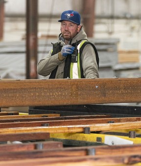 Darryl Logan arranges pieces of wood on the “green line” at the PowerWood mill in Agassiz.