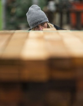 Ashley Clements counts the pieces of lumber while preparing the bundle of wood for shipping at the PowerWood mill in Agassiz.
