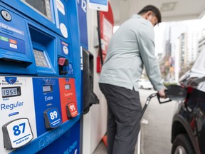 Michael Santos fills up his car in Vancouver on Friday.