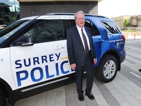 Mayor Doug McCallum poses with a prototype of a new Surrey police vehicle in the first days of his recent term as mayor.  Since then, the police service logo has been updated.