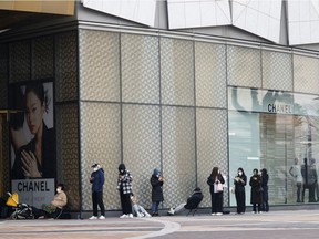 Shoppers line up outside a Chanel store in Seoul, South Korea, March 16, 2022.