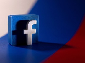 FILE PHOTO: Facebook logo is placed on a Russian flag in this illustration picture taken February 26, 2022. REUTERS/Dado Ruvic/Illustration/File Photo