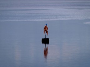 A scarecrow is seen in a tailings pond at the Syncrude Oilsands operation north of Fort McMurray, Alberta.