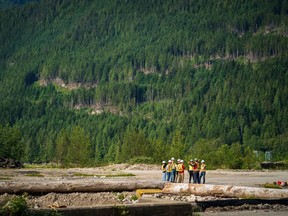 Woodfibre LNG employees meet at the site of the company's future plant, with the Squamish Chief in the background. Photo: Courtesy of Woodfibre LNG