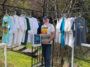 Ian Winn shows off his Sun Run T-shirts from the past 35 years.