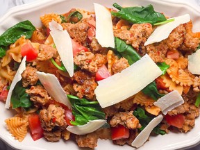 Light and fresh bow tie pasta with spicy sausage, wilted spinach and chunky tomatoes. Makes a quick, bold and delicious meal.