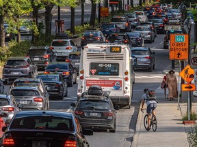 A cyclist sizes up his route on a congested Atwater Ave. in Montreal on Tuesday August 31, 2021.