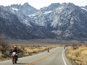 People ride motorcycles beneath the lightly snow-capped Sierra Nevada Mountains on February 20, 2022 near Lone Pine, California. Following record breaking snowfall in December, January and February may be California’s driest ever recorded, exacerbating drought conditions in the state. Winter snow is a critical component of California’s water supply with December through March usually being the wettest months.