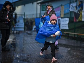 Women and children, make their way through Medyka border crossing from war-torn Ukraine on April 1. The B.C. government has launched a phone line to help Ukrainian refugees and their families to locate and access services.