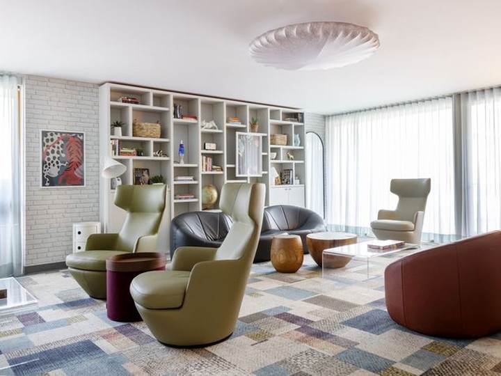  For the teen lounge, interior designer Cathy Radcliffe chose furniture to appeal both to a teen’s privacy (high-back swivel chairs) and small group settings for games and watching films. Muse Sticks ceiling light by Axolight.