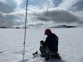 A scientist measures the thickness of the Bologna Glacier at Nahanni National Park in Northwest Territories.