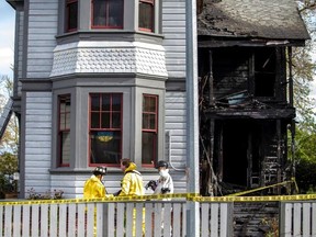 Victoria fire investigators work at home on Caledonia Avenue that was damaged in a fire on Wednesday, April 20, 2022.
