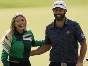 Dustin Johnson walks with Paulina Gretzky after winning the Masters golf tournament Sunday, Nov. 15, 2020, in Augusta, Ga.