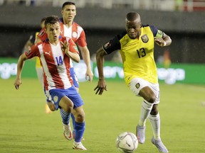 Andrés Cubas of Paraguay, left, competes for the ball with Enner Valencia of Ecuador during a match between Paraguay and Ecuador as part of South American Qualifiers for FIFA Qatar 2022 World Cup at Estadio Antonio Aranda in Ciudad del Este, Paraguay. The Whitecaps are in "advanced discussions" with Cubas, a standout defensive midfielder.
