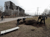 People dig a grave for victims killed during Ukraine-Russia conflict in a street in the besieged southern port city of Mariupol, Ukraine, March 20, 2022.