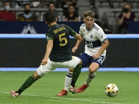 Portland Timbers defender Claudio Bravo defends against Vancouver Whitecaps midfielder Ryan Gauld at B.C. Place.
