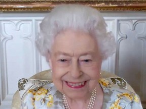 A handout photo released by Buckingham Palace on April 10, 2022, shows a still image taken from footage of a video call between Britain's Queen Elizabeth II, in residence at Windsor Castle, during a call with staff at the The Royal London Hospital in east London, to mark the official opening of the hospital's Queen Elizabeth Unit.