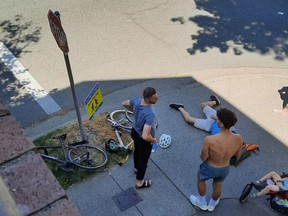 Cyclist Ben Bolliger lies on the ground after being hit by the silver Mercedes in the background at West 7th and Willow in Vancouver in July 2021.