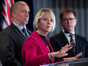 File photo: Provincial health officer Dr. Bonnie Henry responds to questions while B.C. Premier John Horgan, back left, and Health Minister Adrian Dix listen during a news conference about the provincial response to the coronavirus, in Vancouver, on March 6, 2020.