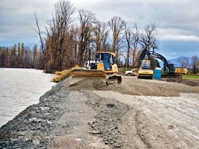 Heavy equipment races on Nov. 23, 2021, to repair the worst breach in the critical Sumas dike in Abbotsford.