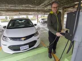 Harry Constantine charging his Chevrolet Bolt at the Mountain Equipment Company head office in Vancouver.