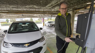 Harry Constantine charging his Chevrolet Bolt at the Mountain Equipment Company head office in Vancouver.