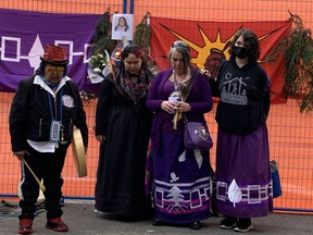 Members of the Oneida Nation at a memorial ceremony for Mary Garlow, a tenant who died in the Gastown Hotel fire, held outside the former site of the Winters Hotel on Friday, April 29.