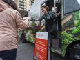 Cindy Hamilton hands food to a customer from the Cultivate food truck parked at St. Paul's Hospital in Vancouver.
