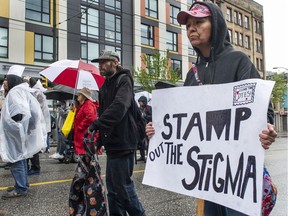 Several dozen protesters march Tuesday, April 26, 2022, in Vancouver, BC, to protest Canada Post's decision to halt postal delivery in 100-block E. Hastings. Blocked Hastings Street.