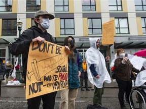 Several dozen protesters march Tuesday, April 26, 2022, in Vancouver, BC, to protest Canada Post's decision to halt postal delivery in 100-block E. Hastings.  Blocked Hastings Street.