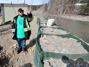 Princeton Mayor Spencer Coyne stands on a reinforced dike. As river levels rise during the annual spring freshet, the town is on edge.