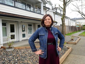 Lilian Chau, contributor to a report on housing by Institute for Municipal Finance and Governance, in front of one of the affordable housing complexes that her organization is responsible for in Vancouver.