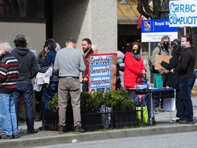 Demonstrators rally outside an RBC branch in Vancouver in an effort to hold the bank responsible for its alleged role in the climate crisis,  in Vancouver, BC., on April 7, 2022. Nick Procaylo photo.