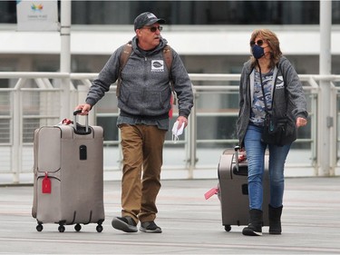 Passengers disembark from The Koningsdam cruise ship at Canada Place  in Vancouver, BC., on April 10, 2022.