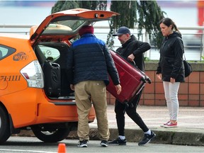 Passengers disembark from The Koningsdam cruise ship at Canada Place  in Vancouver, BC., on April 10, 2022.