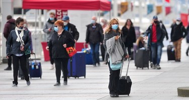 Passengers disembark from The Koningsdam cruise ship at Canada Place  in Vancouver, BC., on April 10, 2022.